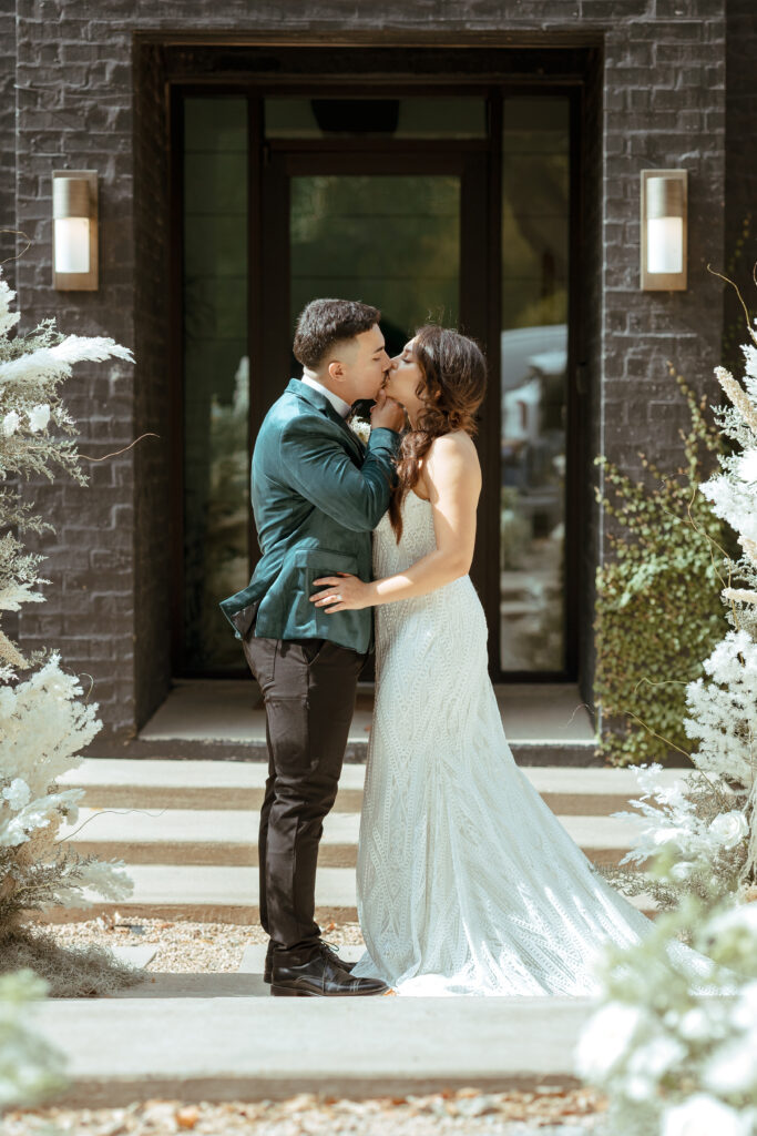 first kiss as husband and wife at wedding venue