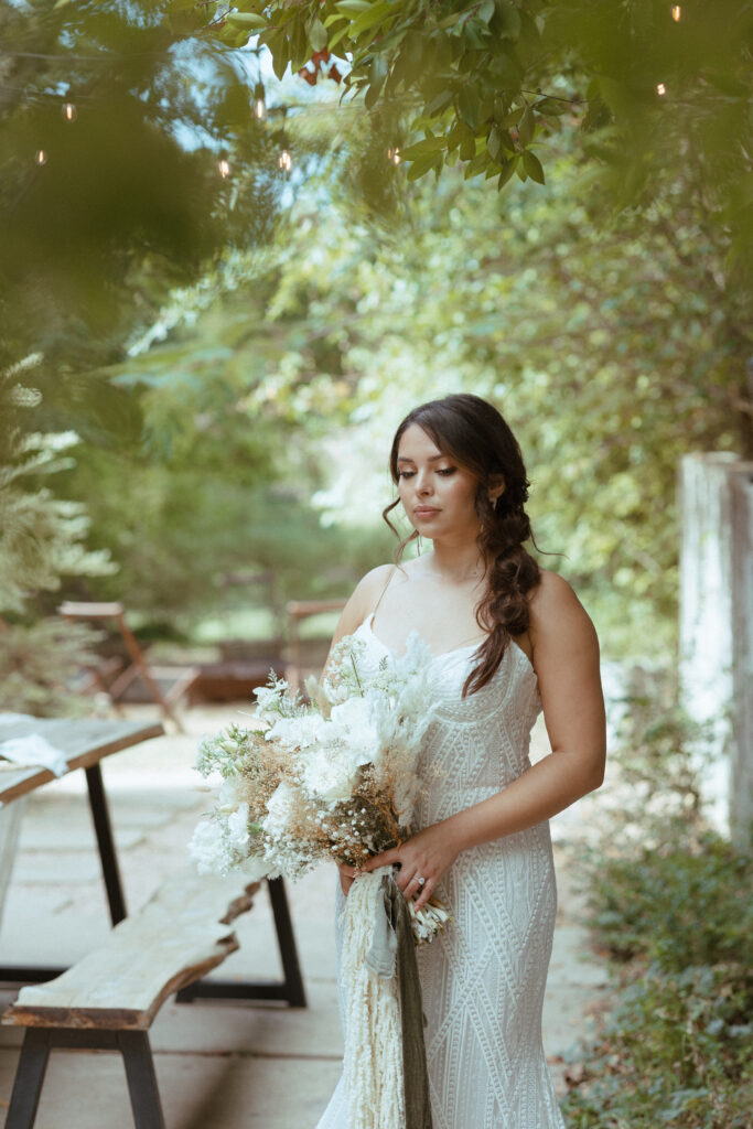 bride with dried floral bouquet in backyard wedding