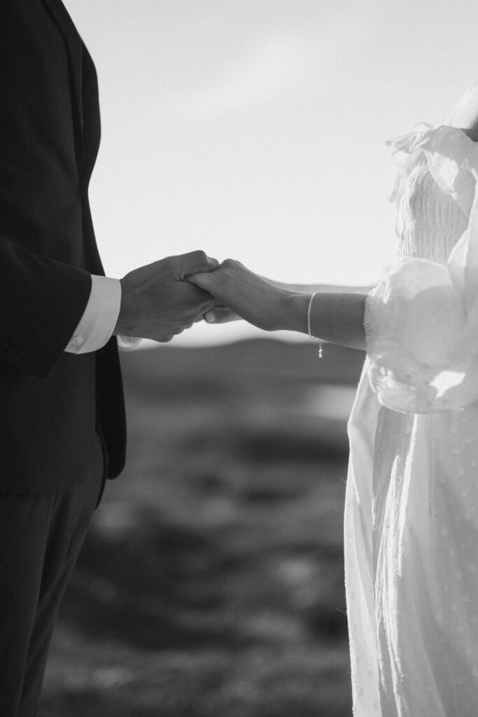 intimate black and white photo of couple holding hands