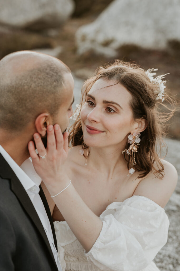 bride touching groom's face staring lovingly into his eyes