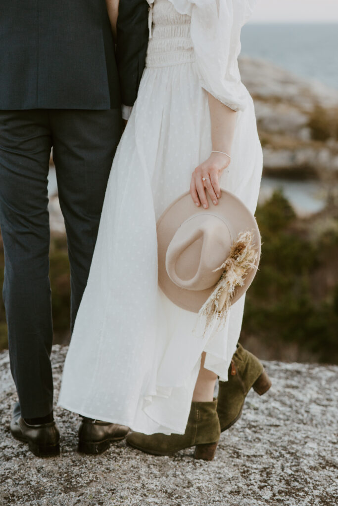 bride holding boho fedora bridal hat