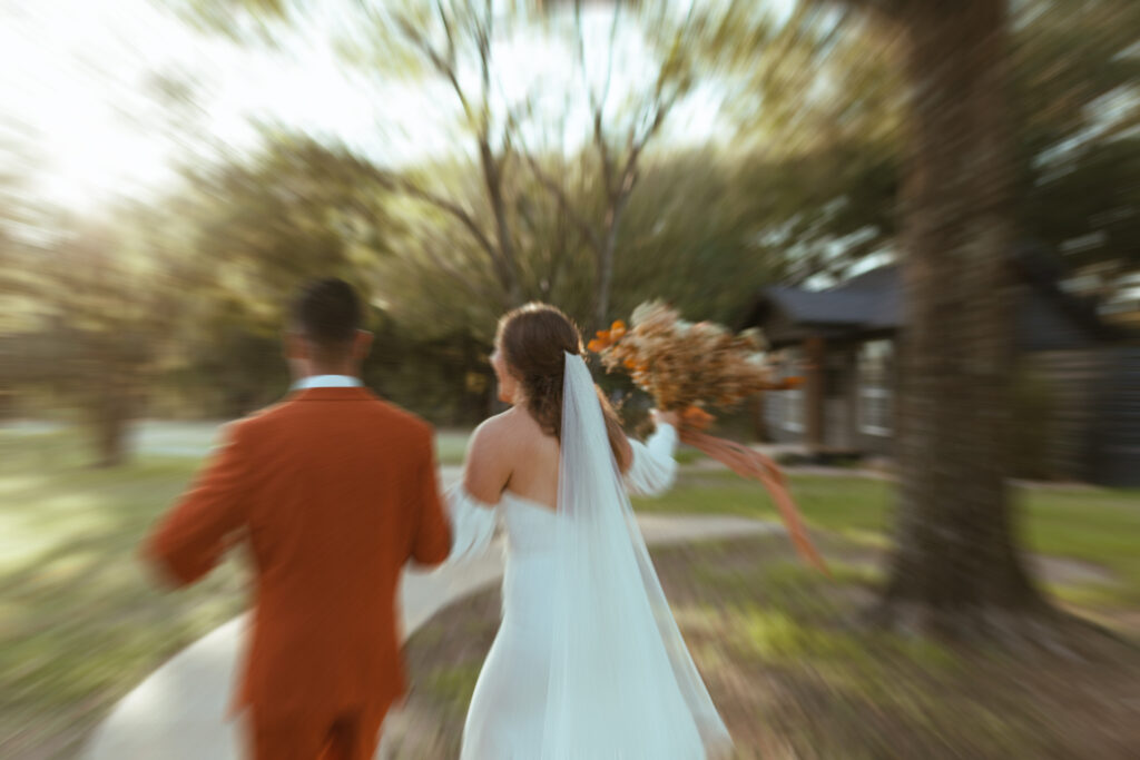 newlyweds running down the aisle excitedly