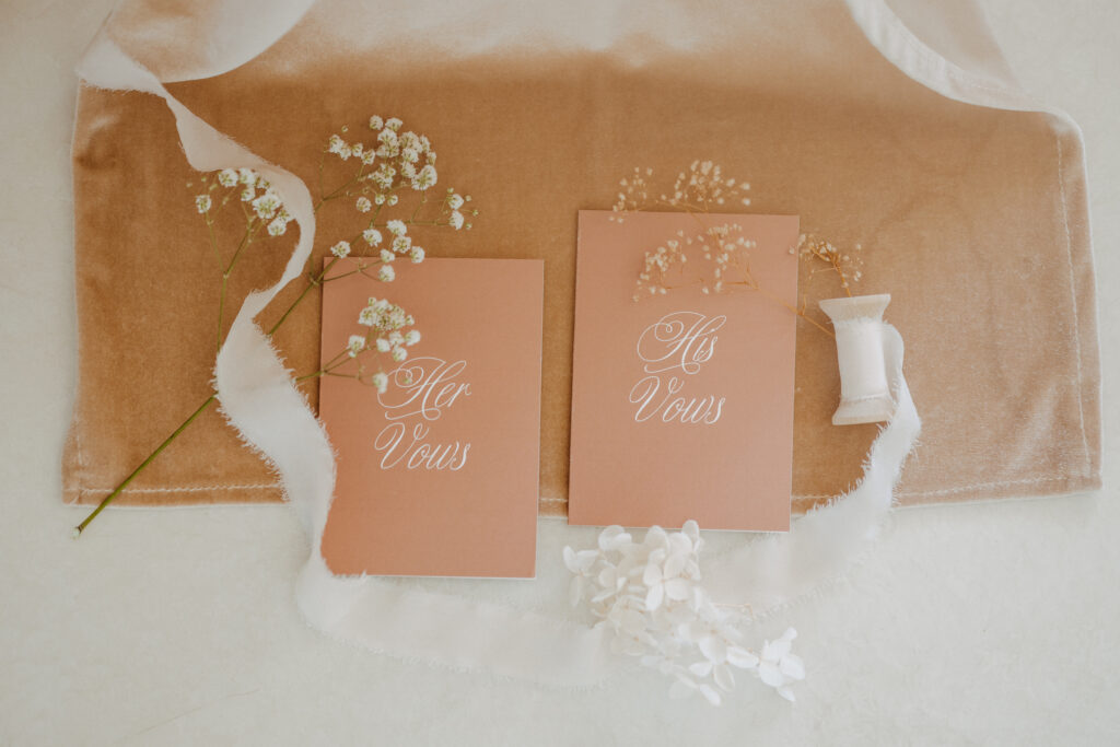 his and her vow books flatlay