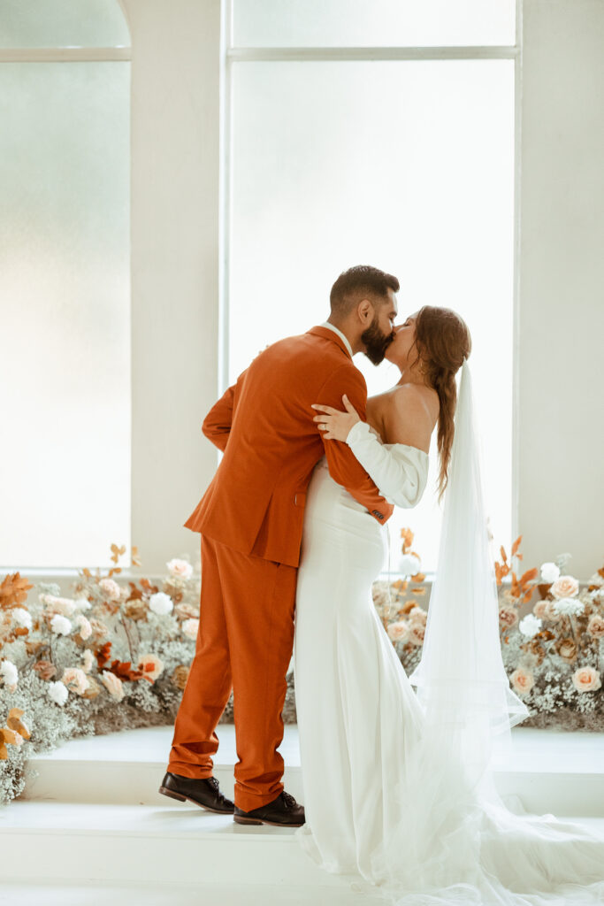 first and groom share their first kiss as husband and wife