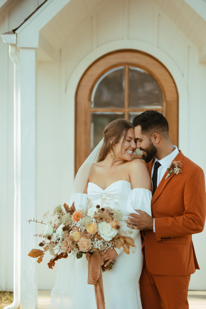 bride with autumn floral bouquet
