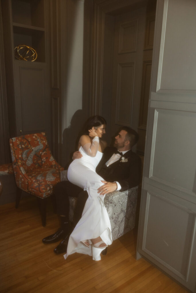 Bride and groom portraits in moody, intimate room at the Halifax Club wedding venue